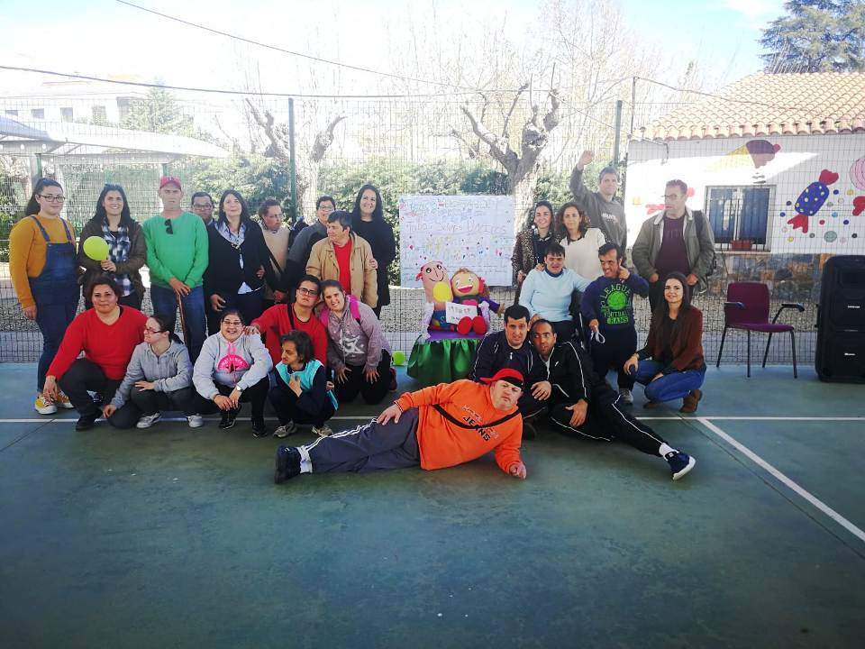 Los usuarios posan ante el cartel creado por los niños y niñas del J. Ballesteros